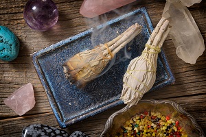 Burning natural white sage incense and multiple gemstones
